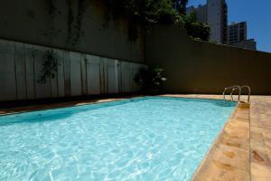 a swimming pool with blue water in a building at Flat Maravilhoso Copacabana (BestHostRio) in Rio de Janeiro