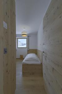 a bedroom with a bed and a window at Chesa Muntanella - Samedan in Samedan