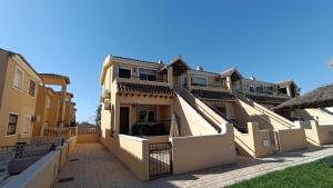 a row of houses with balconies on a street at La Siesta Perfecta in Villacosta