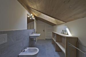 a large bathroom with a sink and a toilet at Chesa Martina - La Punt in La Punt-Chamues-ch +41 photos