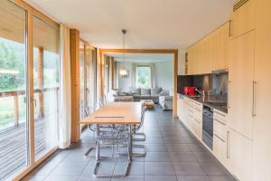 a kitchen with a table and a dining room at Chesa Rivarel - Pontresina in Pontresina