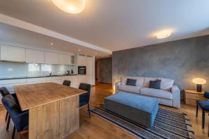 a living room with a couch and a table at Chesa Flugi - Silvaplana in Silvaplana +11 photos