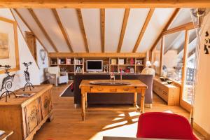 a living room with a couch and a table at Chesa Valluna - La Punt-Chamues-ch in La Punt-Chamues-ch