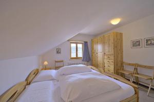 a bedroom with two beds and a window at Chesa Giandains - Pontresina in Pontresina