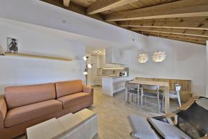a living room with a couch and a table at Chesa Pitz Alv - Pontresina in Pontresina