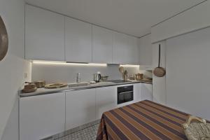 a kitchen with white cabinets and a sink at Chesa Muot Marias - Sils in Sils Maria