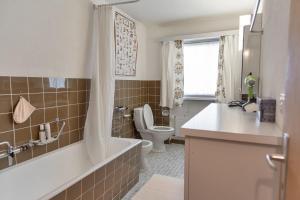 a bathroom with a tub and a toilet and a sink at Chesa Muot Marias - Sils in Sils Maria
