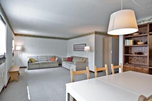a living room with a table and a couch at Chesa Chavriol 2 - Celerina in Celerina
