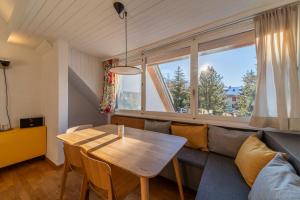 a living room with a couch and a table at Chesa Nair - Surlej in Surlej