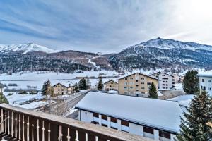 a view of a town with snow covered mountains at Chesa Clus - Zuoz in Zuoz