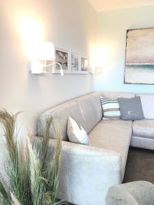a living room with a couch with pillows at STRANDIDYLL, 4 - Typ A4S in Grömitz