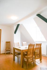 a dining room with a wooden table and chairs at Ferienwohnung Neu "Zum Westerwald" LAHN03 in Löhnberg