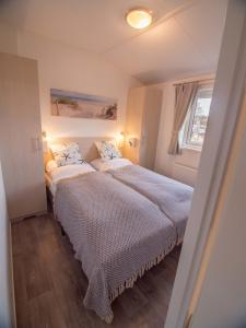 a bedroom with two beds and a window at Strand 13 in Scharbeutz