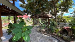 a garden with a gazebo and some plants at kunang kunang in Tetebatu