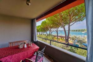 a room with a table with a view of the ocean at Apartments Oliveto - Calming Sea View in Medulin