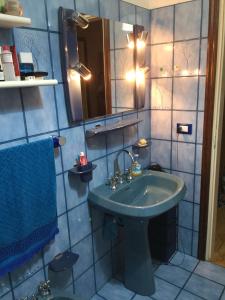 a bathroom with a green sink and a mirror at A casa di mamma in Rieti +24 photos
