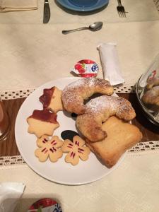 a plate of food with pastries and bread on a table at A casa di mamma in Rieti