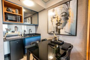 巴鲁埃里Flat com lazer, Wi-Fi e otima localizacao的厨房配有餐桌和水槽