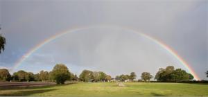 a rainbow in the sky over a field at Bauernhof Sauer - Heuerhus in Varel +1 photo