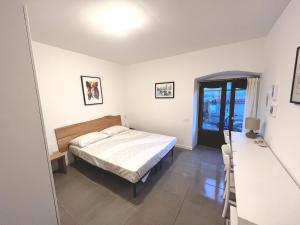 a bedroom with a bed and a window at Scala Santa Apartment in Trieste