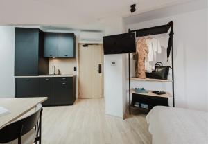 a room with a kitchen and a bed and a room with a kitchen at Appart Hotel Neostelia in Annecy