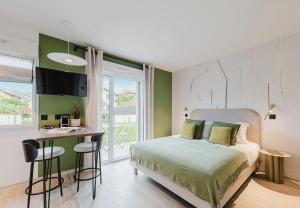 a bedroom with a bed and a desk in it at Appart Hotel Neostelia in Annecy