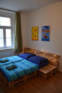 a bedroom with a bed with lights on it at Comfortable Apartment Vlkova in Prague