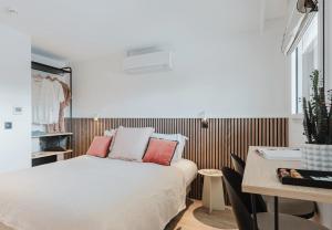 a small bedroom with a bed and a table at Appart Hotel Neostelia in Annecy