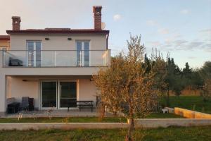 a house with a balcony on the side of it at Olivia Valkanela App 3 in Vrsar