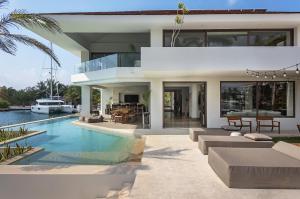 a villa with a swimming pool and a house at Luxury villa 5 bdr oceanfront 5 min walk to cenote in Puerto Aventuras