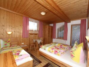 A bed or beds in a room at Apartment in Mayrhofen with a balcony