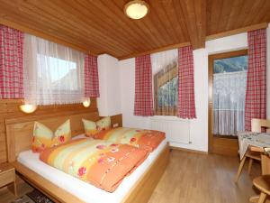 A bed or beds in a room at Apartment in Mayrhofen with a balcony