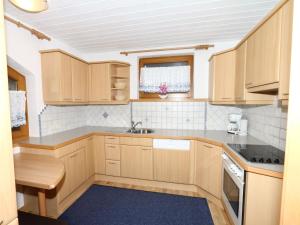 A kitchen or kitchenette at Apartment in Mayrhofen with a balcony