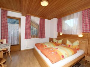 A bed or beds in a room at Apartment in Mayrhofen with a balcony