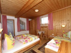A bed or beds in a room at Apartment in Mayrhofen with a balcony