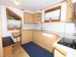 A kitchen or kitchenette at Apartment in Mayrhofen with a balcony