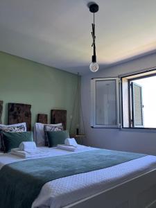 a bedroom with two beds and a window at Assossego House - Gerês in Geres +3 photos