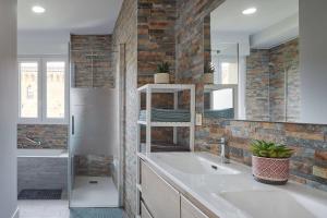 a kitchen with a sink and a refrigerator and a mirror at EARRA - Casa Fabiola, centro y a 2 min de la playa in Zarautz +30 photos