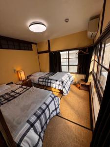 Postel nebo postele na pokoji v ubytování Roku Hostel Hiroshima