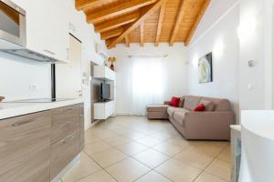 a kitchen and a living room with a couch at Villaggio Sant' Andrea in Caorle