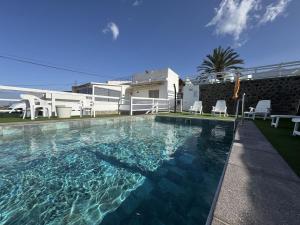 a swimming pool in front of a house at Estancia Lucía in La Orotava