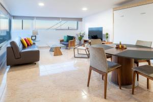 a living room with a couch and a table and chairs at Estancia Lucía in La Orotava
