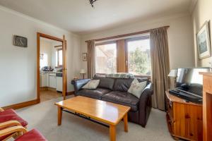 a living room with a couch and a table at Muttoes Apartments - No 3 in St. Andrews