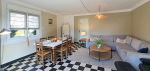 a living room with a couch and a table at Maison Ty Plage in Quiberon