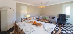 a living room with a white table and a couch at Maison Ty Plage in Quiberon
