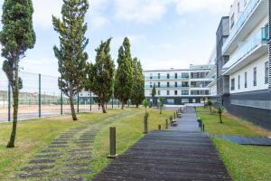 a walkway with trees in front of a building at Rooftop Terrace Apartment PDL in Ponta Delgada