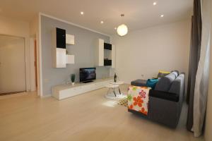 a living room with a couch and a television at Melisa 6 in Poreč