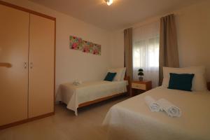 a bedroom with two beds and a window at Melisa 6 in Poreč