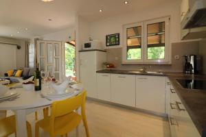 a kitchen with a table and a dining room at Ferienhaus - Bungalow Lavanda 2 in Poreč