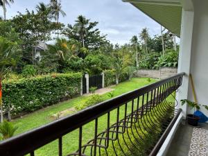 a balcony with a view of a garden at CasaLinda Homestay in Mambajao